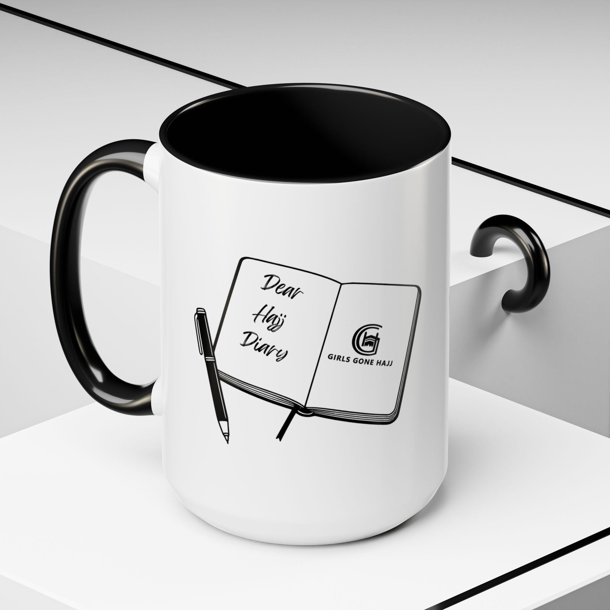 White mug with black interior and handle, featuring a journal with a pen on a white background.