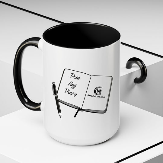 White mug with black interior and handle, featuring a journal with a pen on a white background.