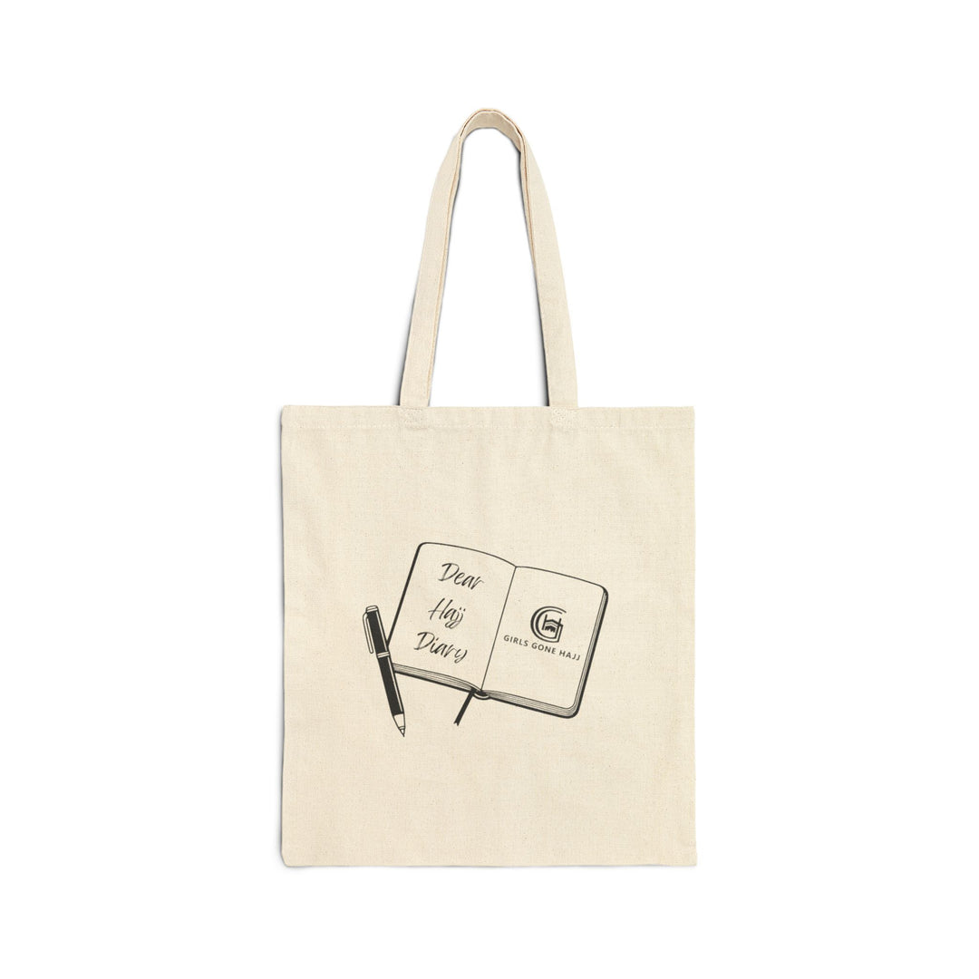 Beige tote bag with a design of an open journal and pen image on a white background.