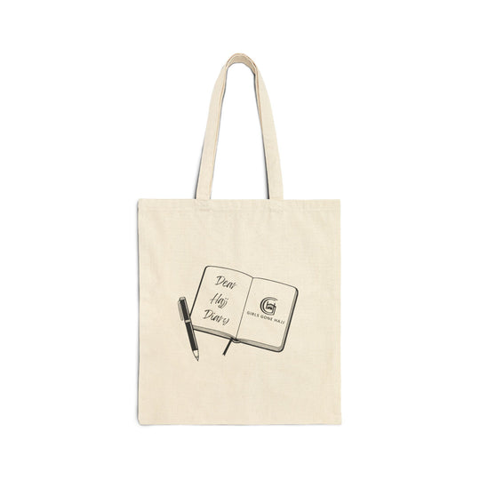 Beige tote bag with a design of an open journal and pen image on a white background.